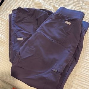 Dark purple FIGS scrubs.